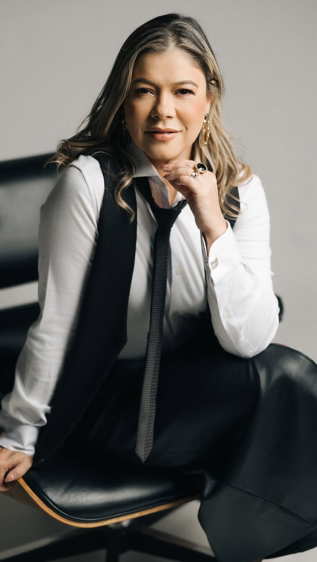Retrato de Daniela Andrade, fundadora da Versat, de camisa branca, colete e gravata